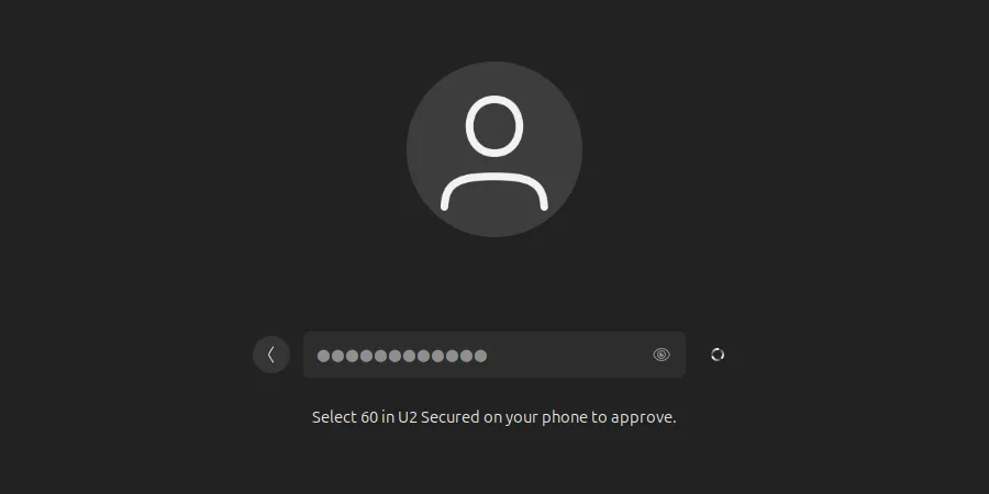 Ubuntu login screen after the password: “Select 60 in U2 Secured on your phone to approve.”, with a spinner beside the field.